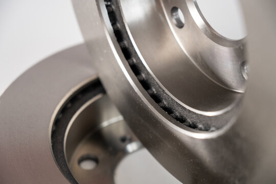 A close-up of new brake discs on a white background.