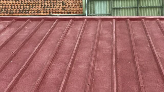 Red rooftop texture with corrugated metal roof pattern