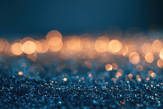 Soft focus, shimmering blue and gold particles with blurred warm bokeh lights above