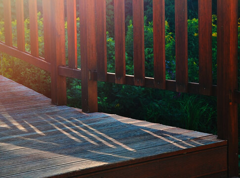 Dramatic light falling on wooden stairs in city park