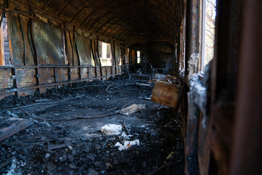 Abandoned Burned Train Car in Railway Yard	