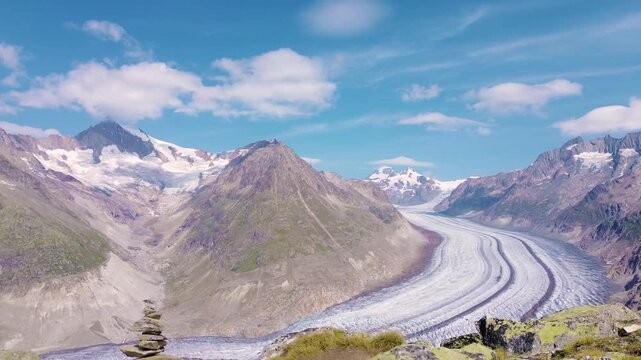 Aerial drone view of the Great Aletsch Glacier surrounded by the Swiss Alps from a mountain summit