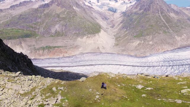 Aerial drone view of the Great Aletsch Glacier surrounded by the Swiss Alps from a mountain summit