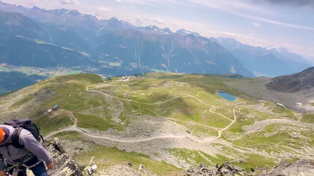 Climbers crossing the via ferrata above the Great Aletsch Glacier in the Swiss Alps