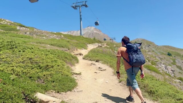 Tourists hiking along the lake with views of the Swiss Alps
