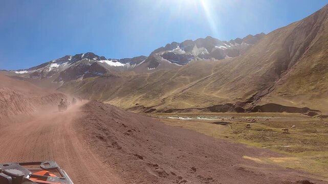 ATV quad bikes riding through the spectacular Andes mountains near Cusco, Peru