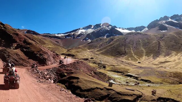 ATV quad bikes riding through the spectacular Andes mountains near Cusco, Peru