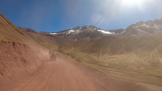 ATV quad bikes riding through the spectacular Andes mountains near Cusco, Peru