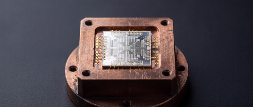 Semiconductor microchip on copper package with wire bonds close-up showing microelectronics engineering