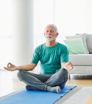 Senior man exercise stretching yoga at home, health care rehabilitation and recovery and active seniors concept
