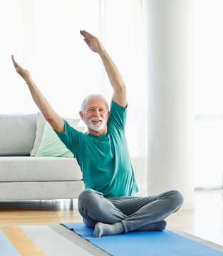Senior man exercise stretching yoga at home, health care rehabilitation and recovery and active seniors concept