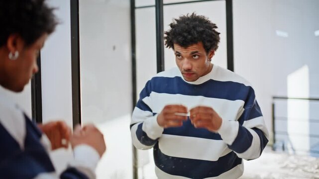 Portrait man rehearsing speech looking mirror reflection indoors. Nervous guy