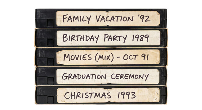 Stack of old VHS tapes with handwritten labels from the 1990s