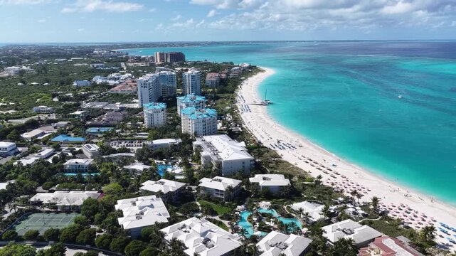 Grace Bay Beach At Providenciales In Overseas Territory Turks And Caicos Islands. Caribbean Beach. Tropical Scenery. Stunning Highrise Buildings. Grace Bay Beach In Turks And Caicos Islands. 