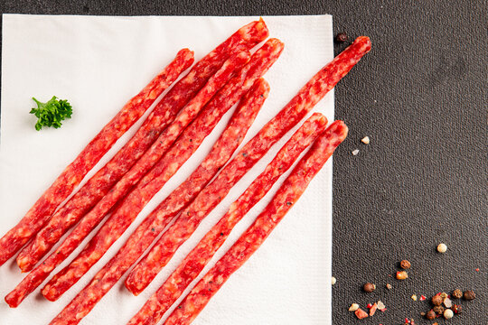 Kabanos sausages smoked appetizer&nbsp;dried meat thin sausages cooking dish tasty snack fresh and delicious gourmet rustic food background on the table&nbsp; rustic food top view copy space