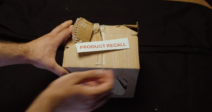 Damaged or defective product package marked Product Recall. Ideal for product defects, quality issues, safety recalls, manufacturing and quality control.