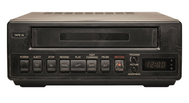 Vintage VCR player with visible buttons and digital display showing time