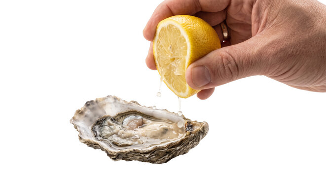 Hand squeezing fresh lemon juice onto a raw oyster on the half shell