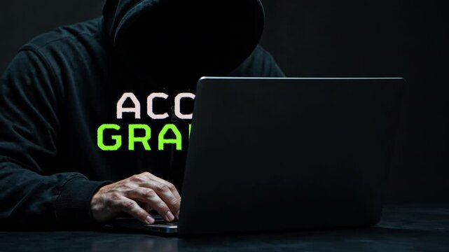 Hooded Laptop User with Access Granted Text in Dark Cybersecurity Scene