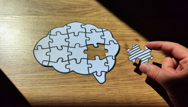 Mental health concept. A missing piece of the brain puzzle on wooden background.