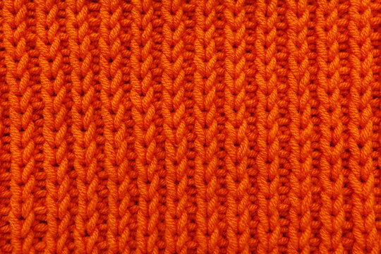 Bright orange knitted fabric texture close up