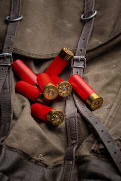 Red shotgun shells on vintage backpack