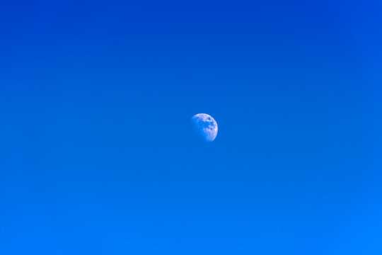 The moon in the blue sky