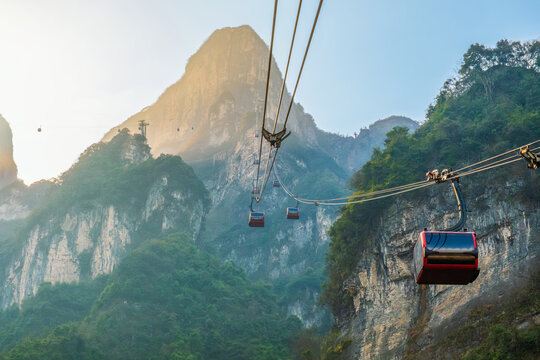 Cable car travel above limestone peaks of Tianmen Mountain in Zhangjiajie, Hunan, China. Mountain scenery travel destination, outdoor adventure, nature tourism in Tianmen Mountain National Forest Park