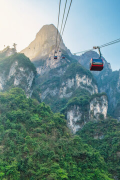Cable car cabin travel across steep cliffs at Tianmen Mountain near Zhangjiajie, Hunan, China. Mountain transport, tourism infrastructure, engineering, exploration and high-altitude travel in Asia