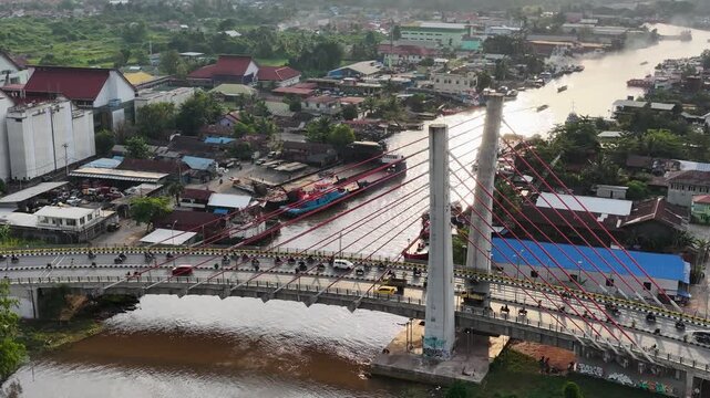 A view of Banjarmasin city and the Alalak River Bridge (or Basit Handil Bakti Bridge) in the late afternoon