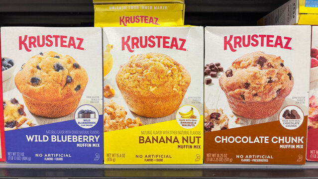 Krusteaz muffin mix baking display at a grocery store. Krusteaz has removed artificial colors from muffin mixes.