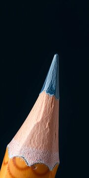 Sharpened lead tip emerging from wooden pencil case, sharpness, detail-oriented