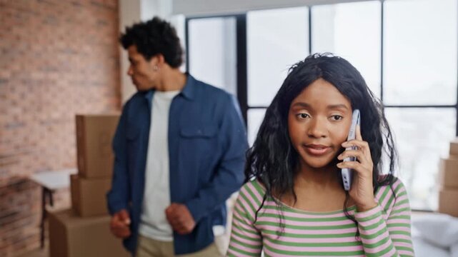 Sad woman calling smartphone feeling overloaded new purchased apartment closeup