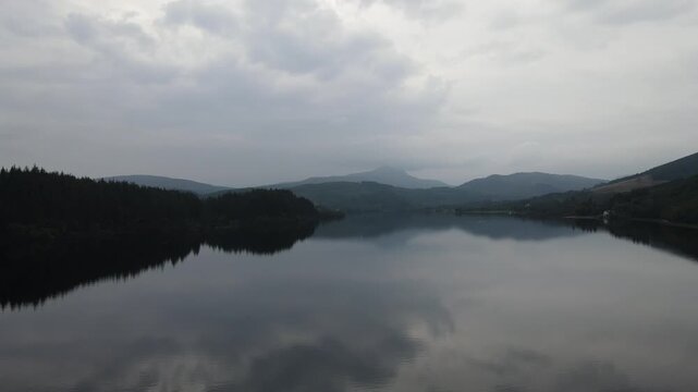 Aerial Rising over Mirror-Flat Loch Ard towards Ben Lomond on a Grey Overcast Day, Scotland