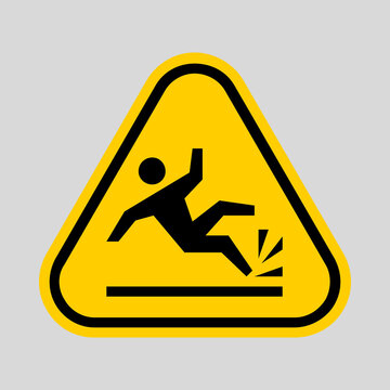 Yellow triangular warning sign depicting a person falling onto a hard surface, indicating a slip, trip, or fall hazard.