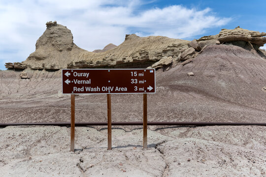 Ouray/Vernal sign with formations in the background