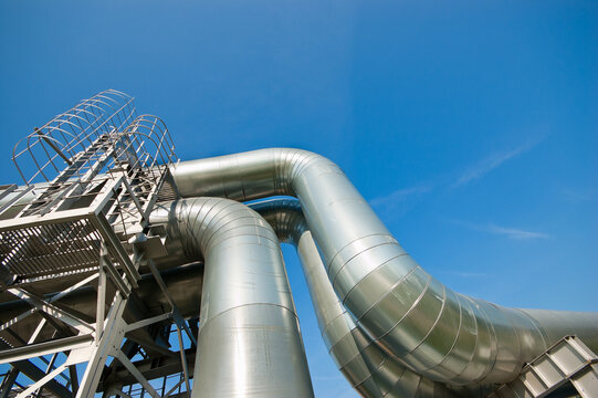 The photo shows a pipeline against a blue sky