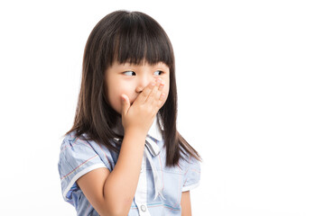 Little girl covering her mouth with hands, feeling shocked or keep a secret.