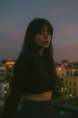 Fototapeta premium Young Woman in City at Dusk