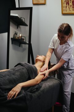 Woman enjoying relaxing arm massage in spa