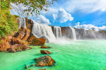 Wide angle view of a powerful tropical waterfall flowing into a turquoise pool with waterfall landscape tropical ©  SobuzForge
