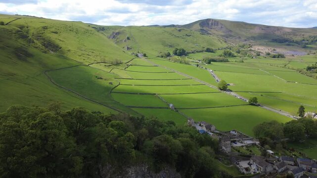Aerial view of the dramatic Cave Dale limestone valley with a hiking path, Castleton, Peak District, England