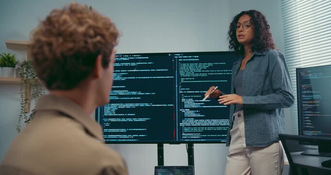 Diverse team software developer present coding on screen to colleague at office. Mentor coaching program leader, Creative startup teamwork discussion, Artificial intelligence system workshop concept.