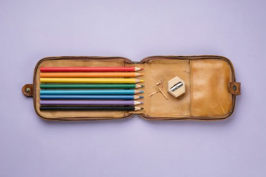 Colorful pencils in vintage leather pencil case, Rainbow colored pencils set, Art supplies on pastel background, Creative stationery for drawing and design