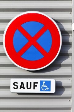 No stopping or parking road sign on a wall except for people with disabilities in France
