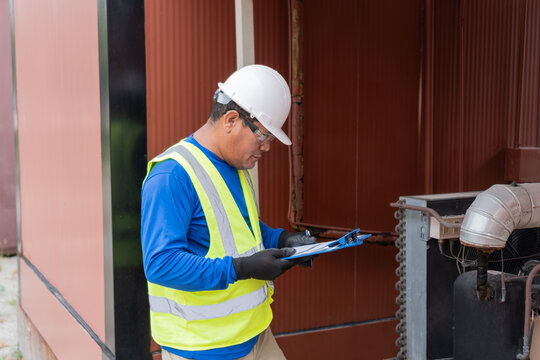 Worker checking industrial equipment on site