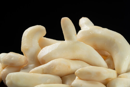 Pile of fresh peeled white turmeric on black background.