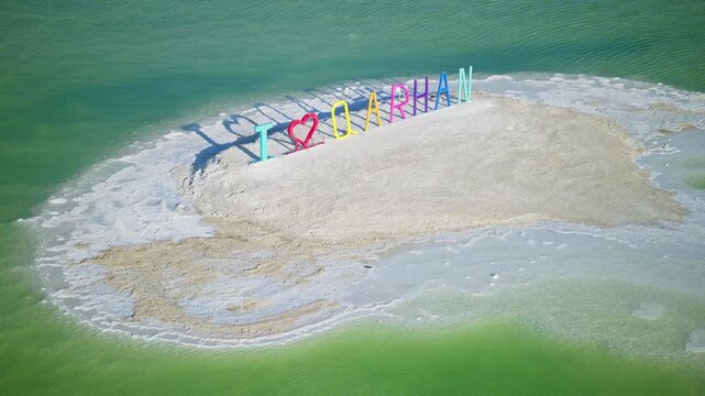 Aerial View of Colorful "I Love Qarhan" Letter Landmark in Qarhan Salt Lake: Pure Emerald Water and White Salt Flat in Qinghai