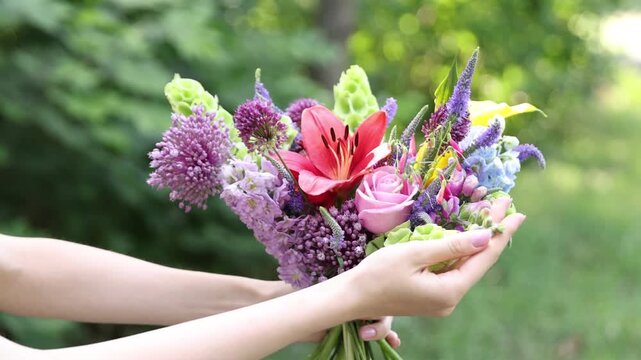 Woman with bouquet of beautiful summer flowers outdoors, closeup