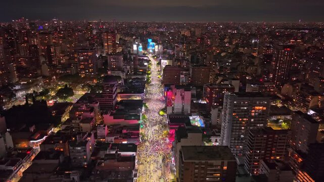 Argentina soccer supporters wearing the national colors celebrating the World Cup semifinal win over England in Buenos Aires on July 15, 2026; extended aerial reveals avenue and skyline.